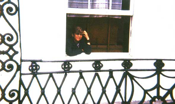 Douglas Manry at window overlooking The Greenbank Hotel gardens, Falmouth, England.